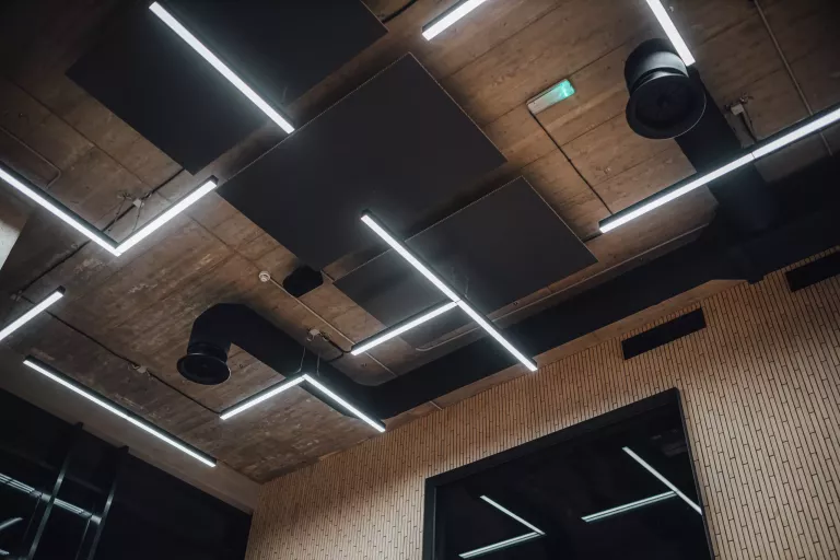 View on modern led lightning hanging from ceilings, industrial building concrete texture